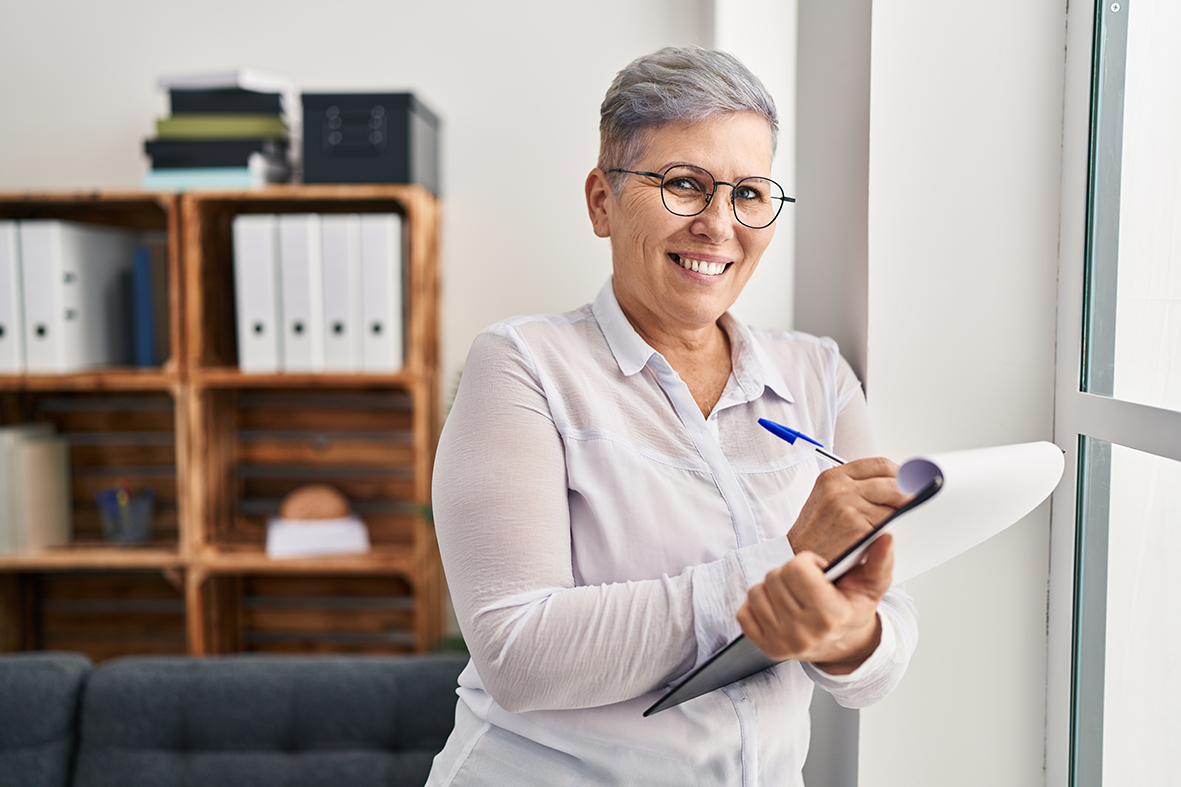 Médica em pé prescrevendo remédio em receita